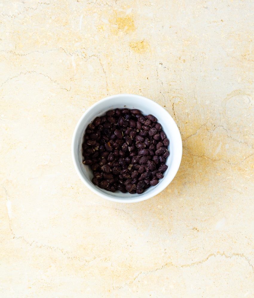cooked black beans in white bowl