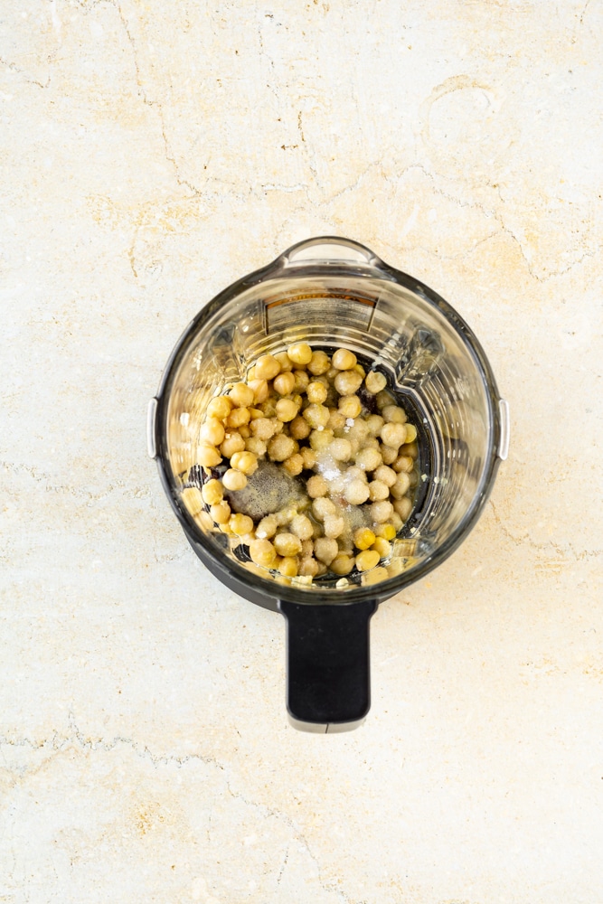chickpeas, minced garlic, tahini, lemon juice, lemon zest, salt, beet, cumin, olive oil, and coriander in an instant pot blender.